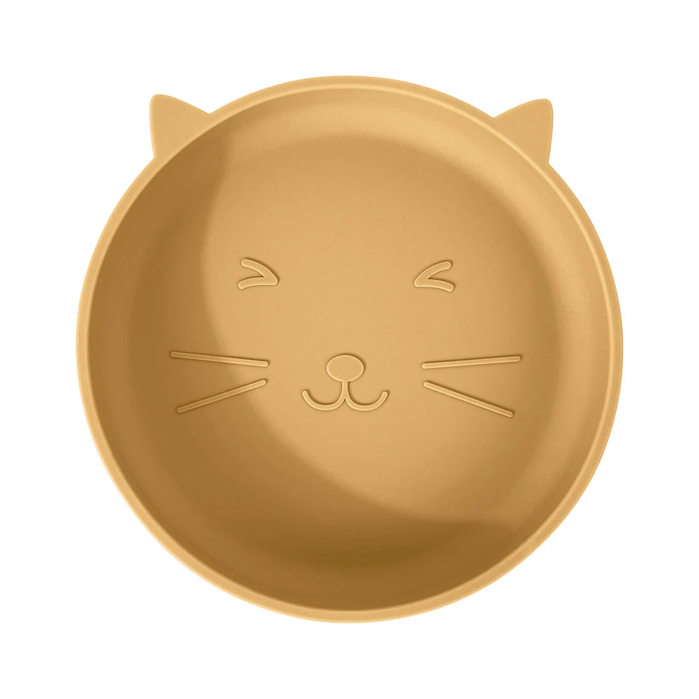 Gold-colored plate shaped like a cat's face on a white background