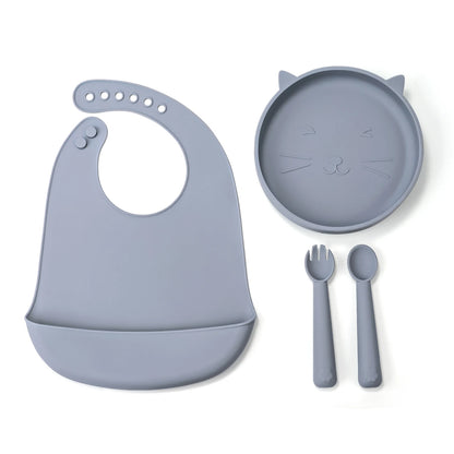 Children's silicone dinner set with plate, bowl, fork, and spoon on a white background