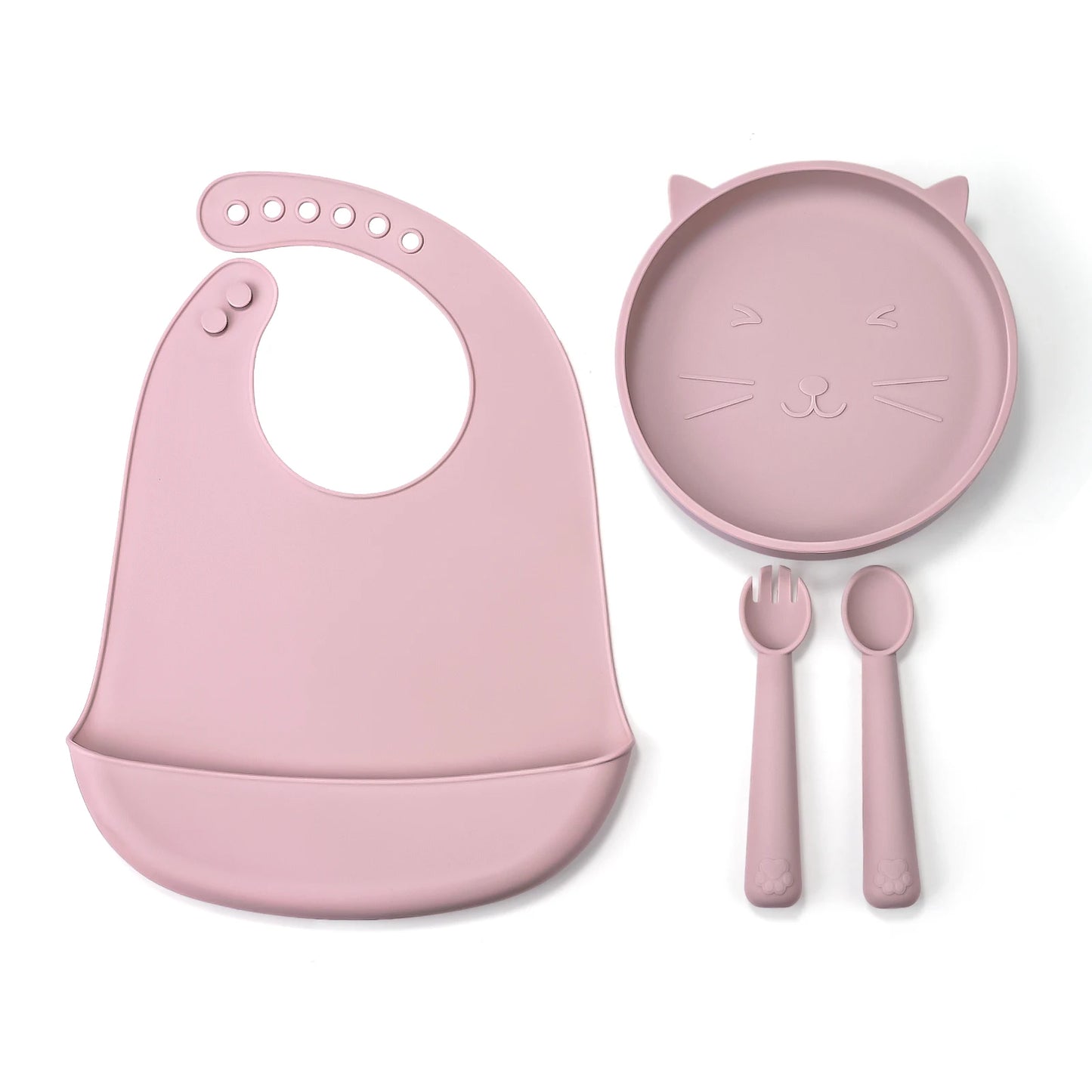 Pink baby bib, plate, fork, and spoon set on a white background