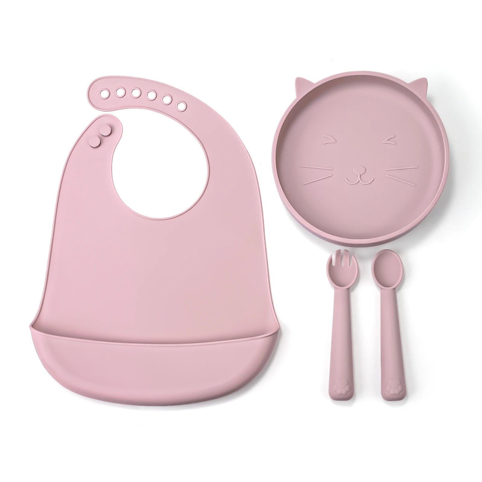 Pink baby bib, plate, fork, and spoon set on a white background