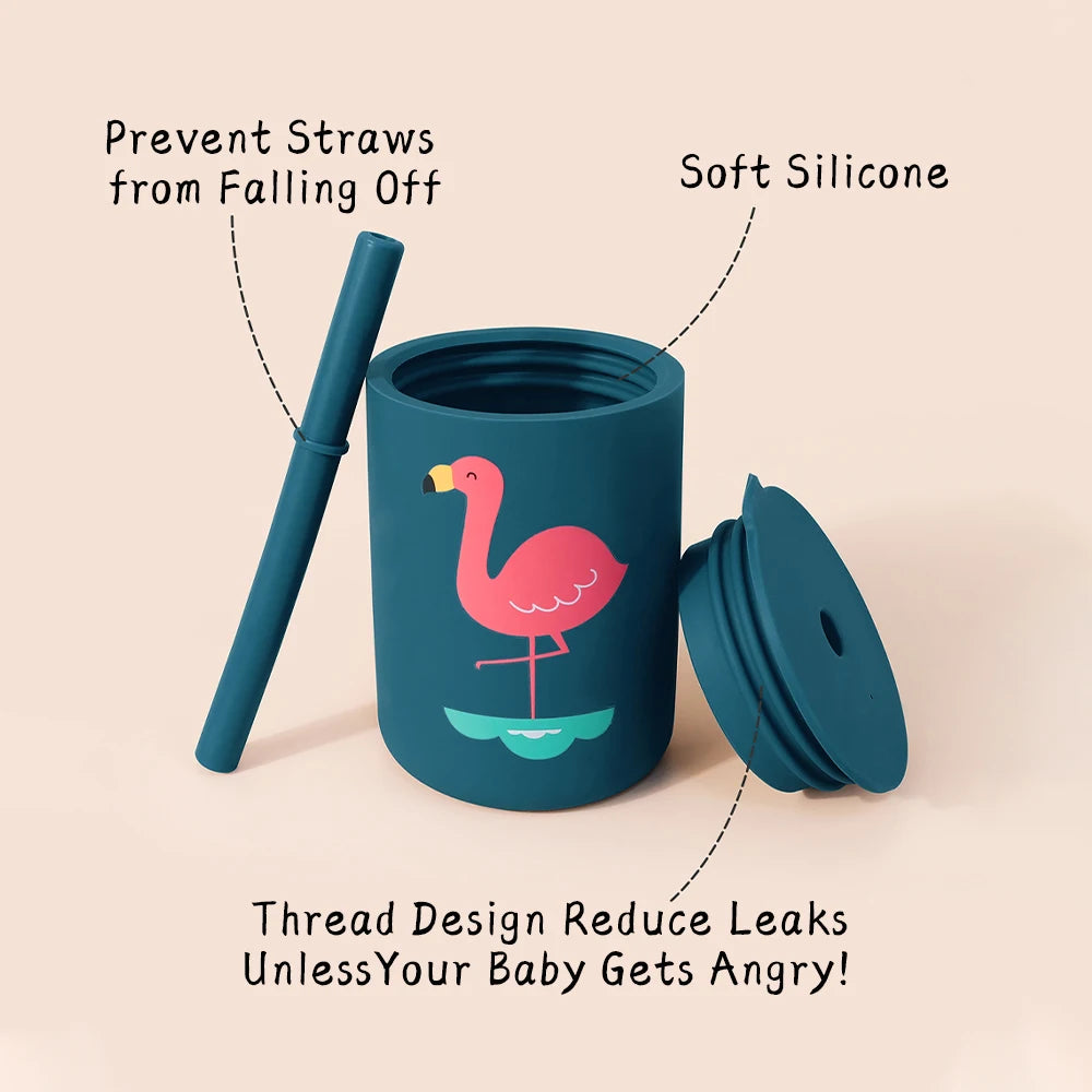 Teal children's cup with flamingo design, straw, and lid on a beige background.