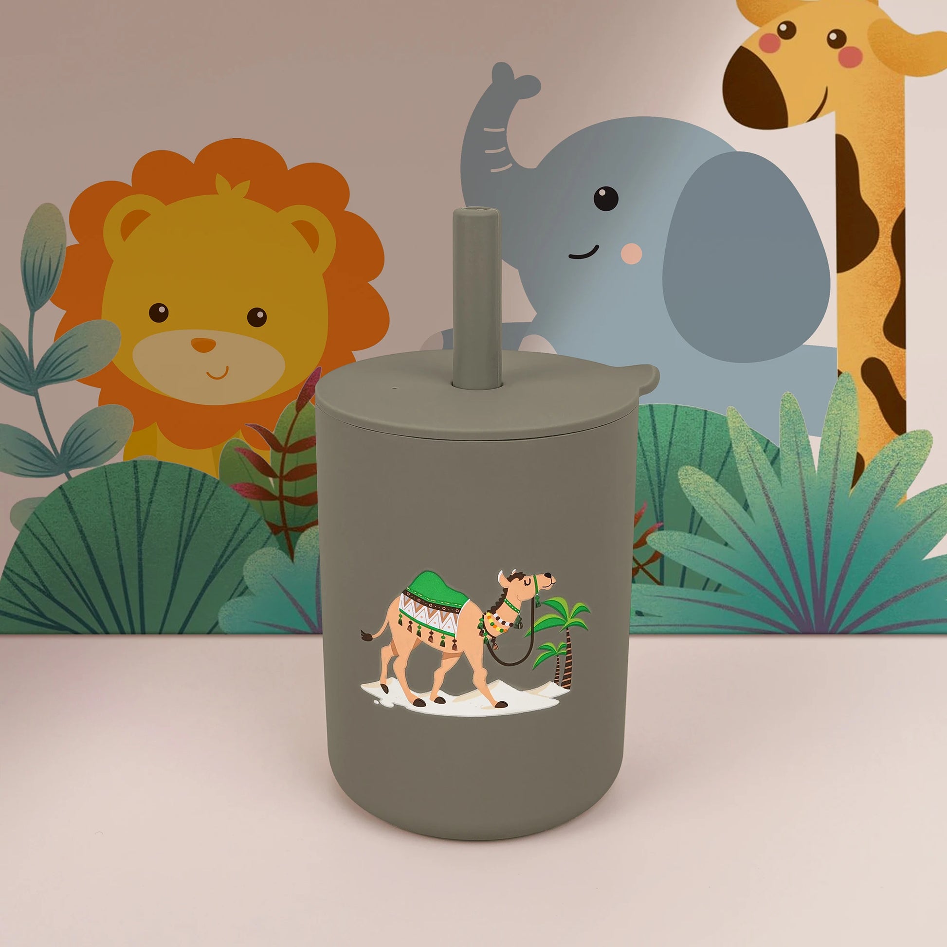 Green tumbler with a camel design against a colorful jungle-themed background