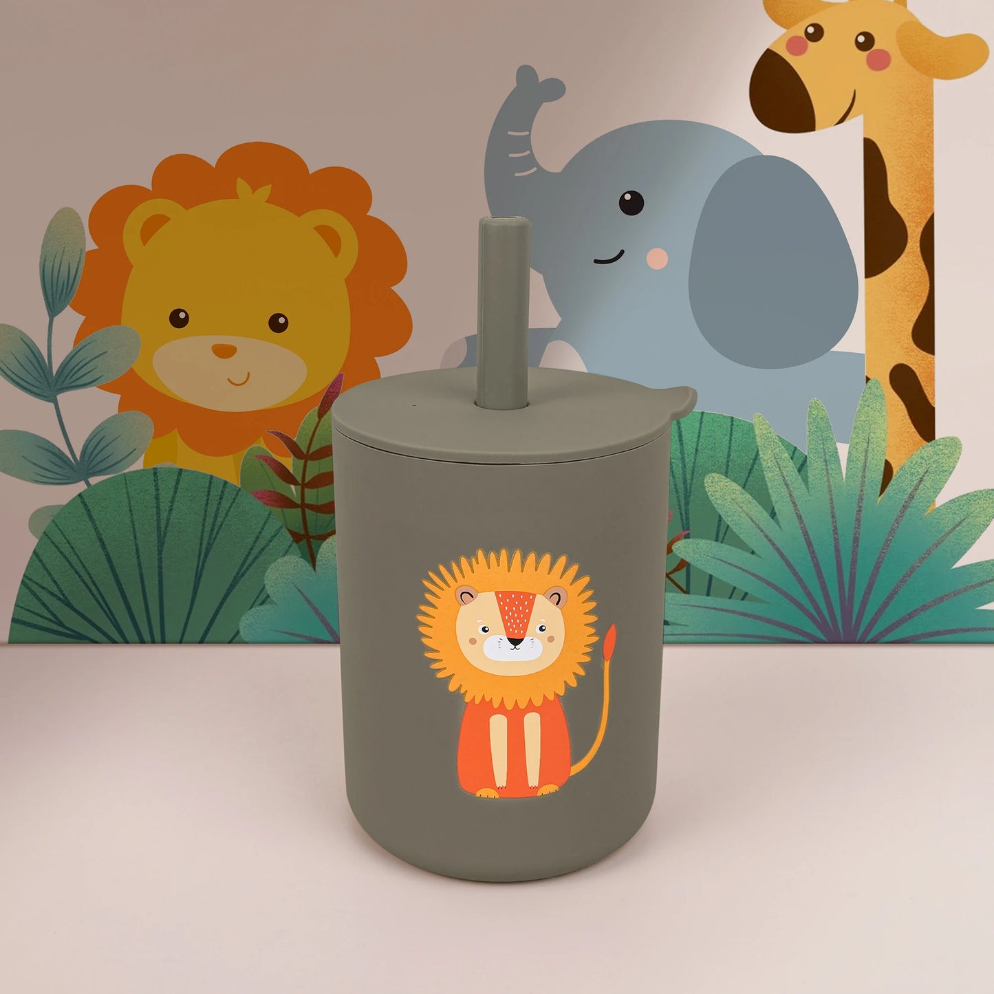 Children's tumbler with lion design in front of a jungle-themed backdrop with lion, elephant, and giraffe.