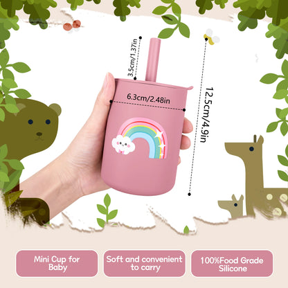 Pink mini cup with rainbow design held by a hand, surrounded by cartoon animals and leaves.