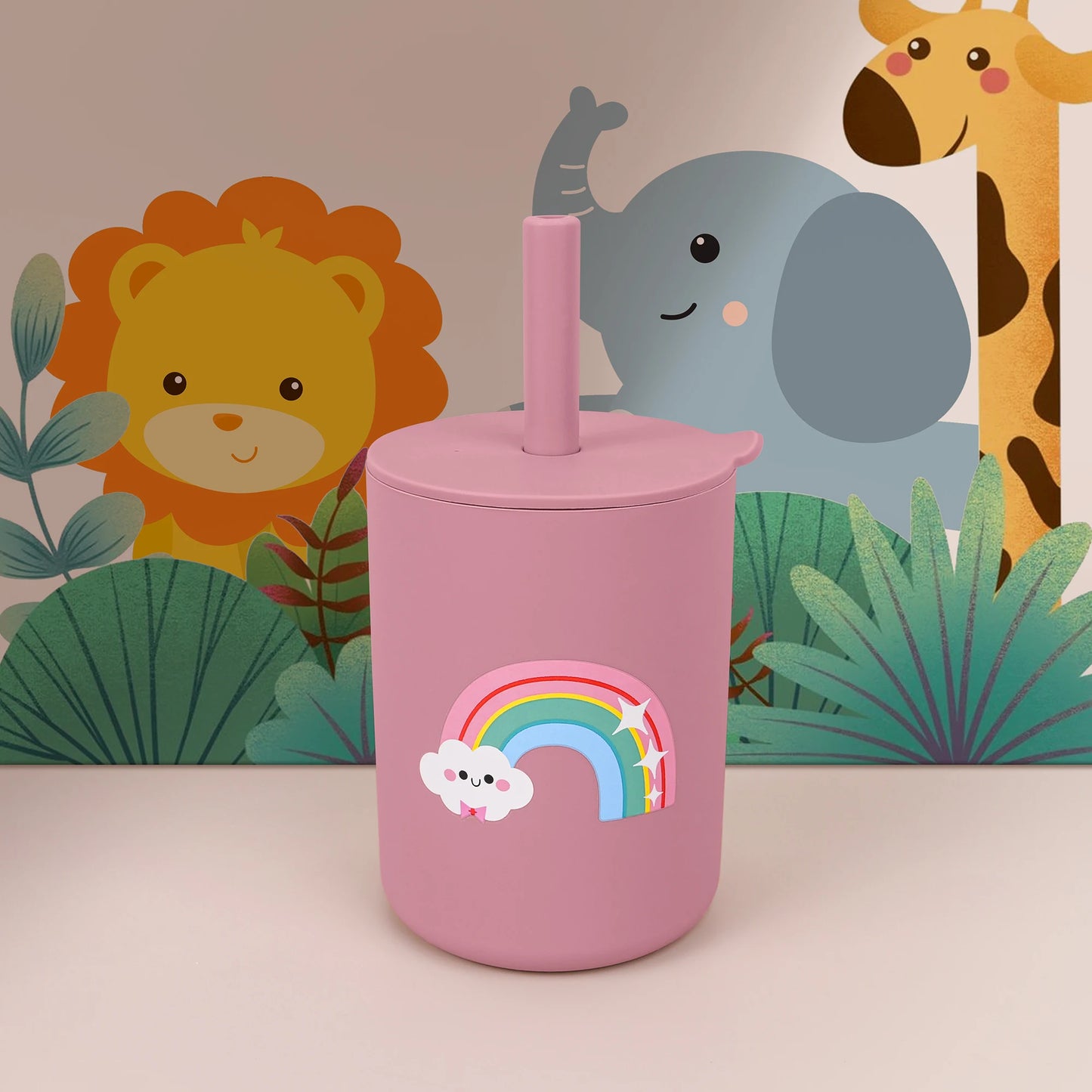 Pink tumbler with rainbow design against a colorful animal-themed background