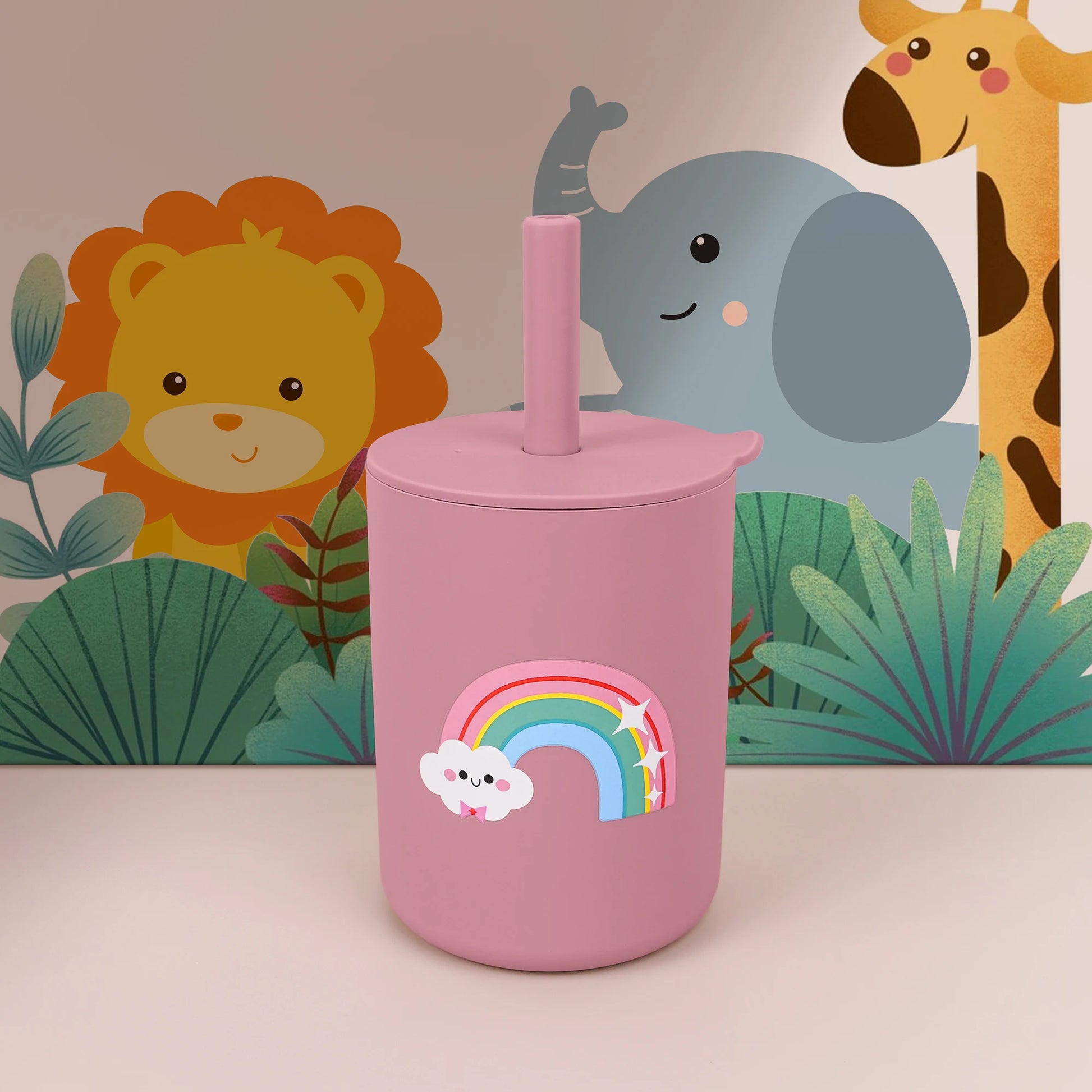 Pink tumbler with rainbow design against a colorful animal-themed background