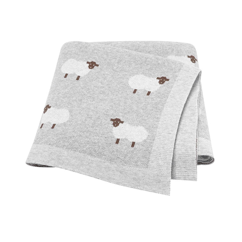 Soft Grey knitted baby blanket with a white sheep pattern, perfect for a gender-neutral modern nursery.