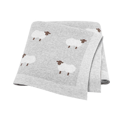 Soft Grey knitted baby blanket with a white sheep pattern, perfect for a gender-neutral modern nursery.