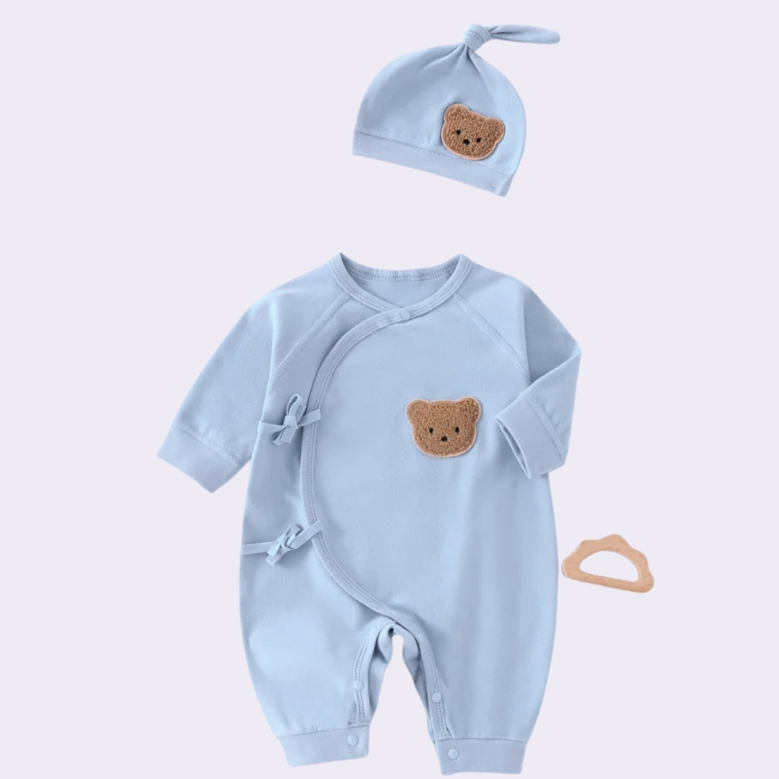 Light blue newborn side-snap jumpsuit and beanie set with cute bear face patch, soft polyester fabric.
