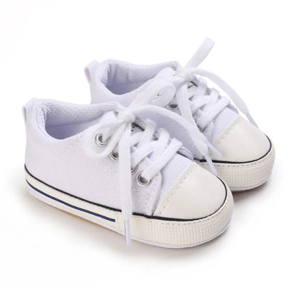 All-white infant canvas crib shoes, perfect for baptism, christening, or athletic stadium style.