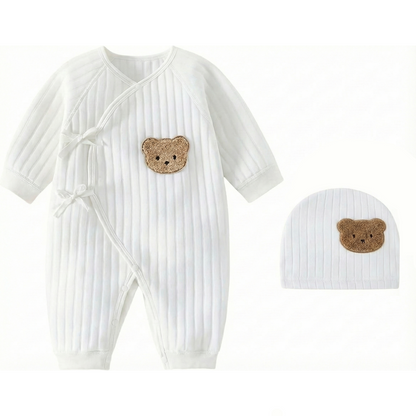 White side-snap baby kimono bodysuit made of soft ribbed cotton with a brown bear patch and matching hat.