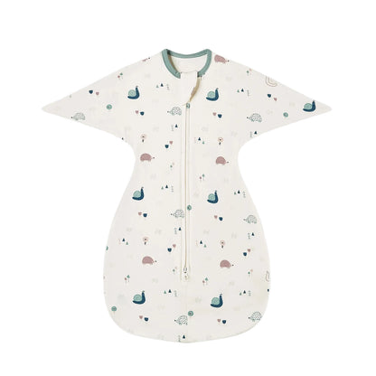 Cream-colored wearable blanket featuring whimsical woodland illustrations of snails, hedgehogs, and trees.