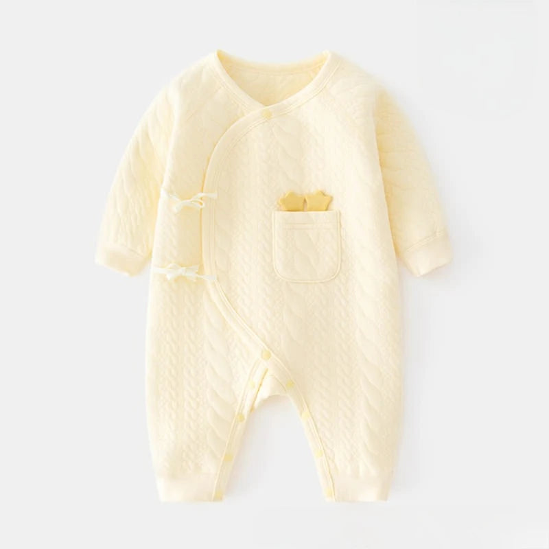 Pale yellow newborn kimono bodysuit made of soft quilted cotton. Features a side-snap wrap design and a front pocket with cute yellow star details.